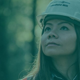 Woman in hard hat in the forest
